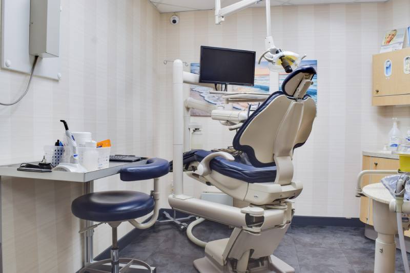 promise-to-our-patients man smiling in dentists chair